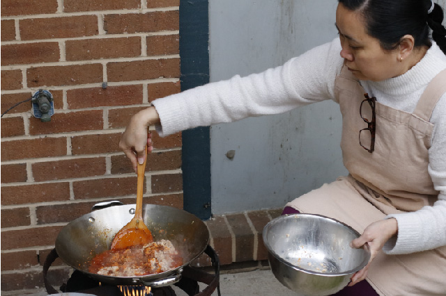 adding fish to wok